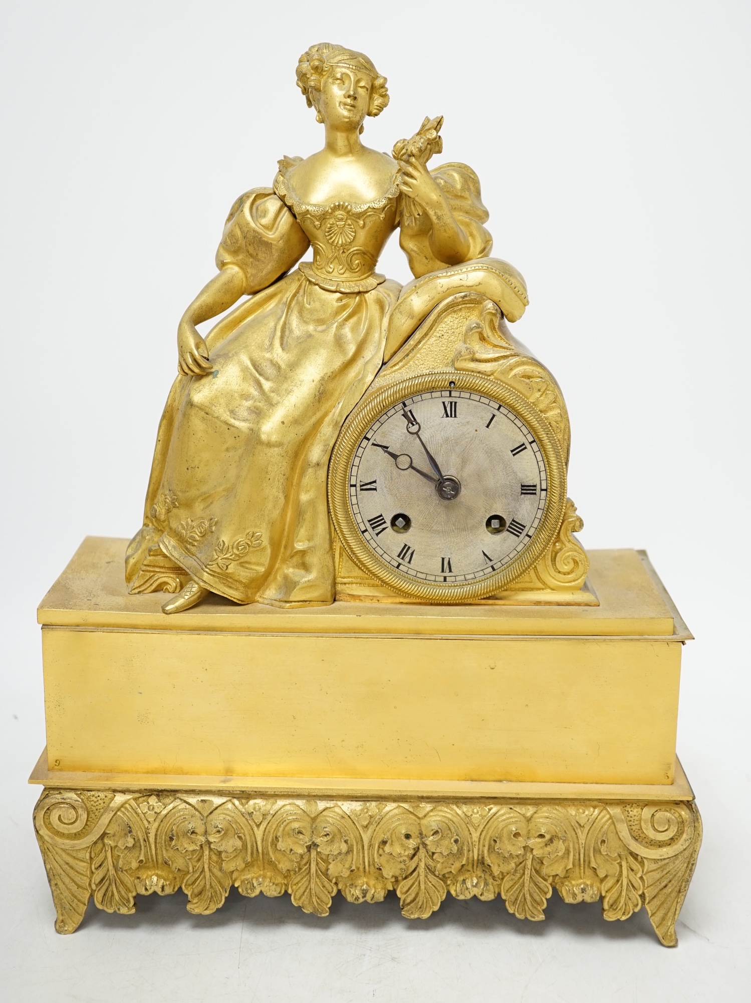 A 19th century French ormolu mantel clock, surmounted with a lady, with key and pendulum, 36cm high. Condition - poor